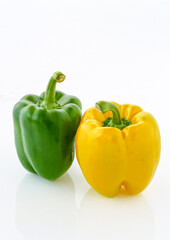 Yellow and green peppers on white background