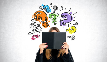Woman student with book and question marks