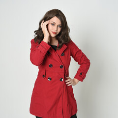 head and shoulders close up portrait of beautiful brunette woman model, wearing red trench coat...