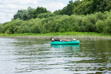 people are floating on the river in an inflatable boat. The concept of outdoor activities and...