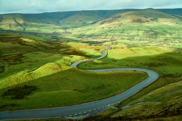 Winding road through green fields in England