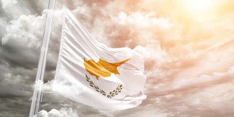 Cyprus national flag cloth fabric waving on beautiful cloudy Background.