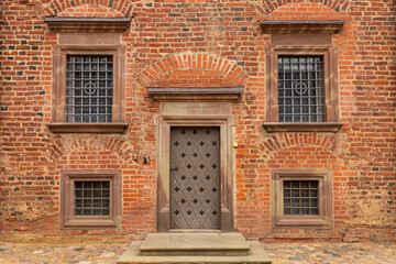 Fototapeta premium Ancient walls rich in history, bricks and stones, arched doors and windows of Mir Castle.