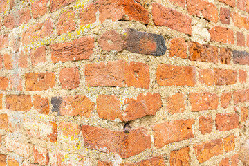 Naklejka premium Old Brick wall surface close up. Bricks wall Texture. Loft interior and exterior design. Bricks in the wall. Brickwork close up view. Natural vintage stone walls pattern. Antique stonework Texture.