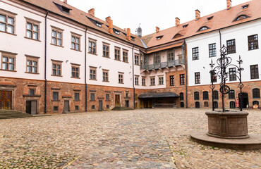 The well-kept courtyard of the ancient European castle Mir. - obrazy, fototapety, plakaty
