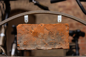 Clay brick sign on the background of the old castle walls, vintage image.