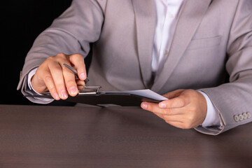 Concept, guy is studying a loan agreement. Concept, thinks how to cut costs. A businessman is...