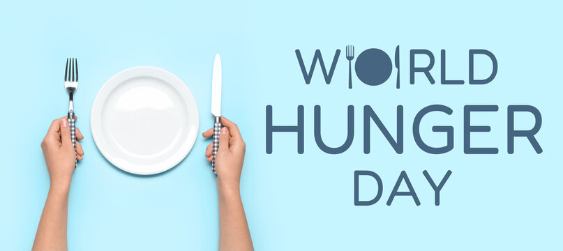 Female hands with empty plate and cutlery on blue background