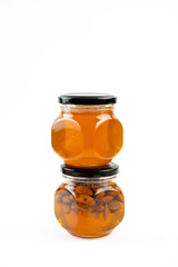 Jar of honey with nuts on white background