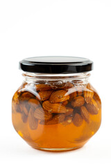 Jar of honey with nuts on white background