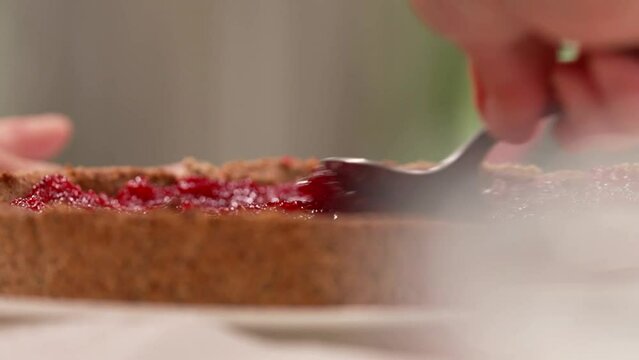 the pastry chef spreads jam on the cake