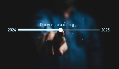 Businessman touching on download bar status to change from 2024 to 2025  for countdown of merry Christmas and happy new year by technology concept, Start new business and new life.