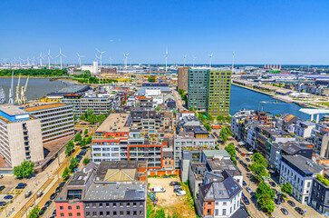Antwerp cityscape, aerial panoramic view of Antwerp city Eilandje quarter neighborhood with port area, water canals, windmills on skyline horizon, panorama of Antwerpen, Flemish Region, Belgium