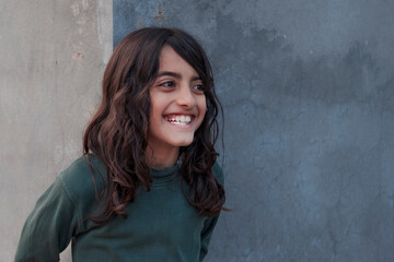 portrait of a middle eastern boy with long hair
