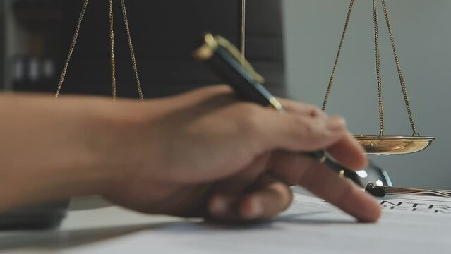 Business and lawyers discussing contract papers with brass scale on desk in office. Law, legal services, advice, justice and law concept picture with film grain effect