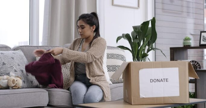 House, woman and donation of clothes in box, face and charity organisation in packing as volunteer. Person, humanity support or portrait by clothing in spring cleaning, kindness or npo in living room