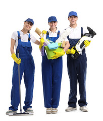 Workers of cleaning service with supplies on white background