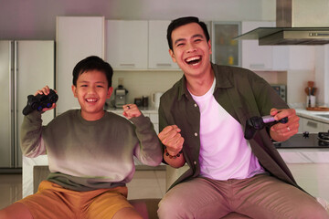 Happy excited father and son celebrating winning videogame