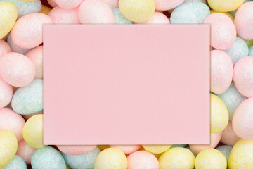 Blank pale pink greeting card with colorful pastel Easter eggs candy - 772150627