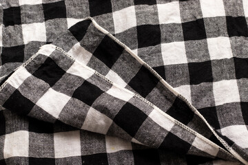 Gingham napkin with black and white checks close up.