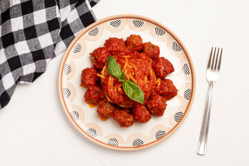 Spaghetti with meatballs in tomato sauce.