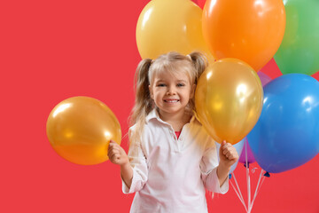 Cute little girl with colorful balloons on red background