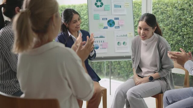 Circle diverse group asia people workshop eco go green seminar meeting class protect Future growth Net zero waste ESG unity office. Young adult asian man woman smile clap hand applaud happy team ideas