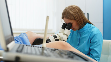 Gynecological office in the clinic. A gynecologist examines a young patient in a modern clinic. A...