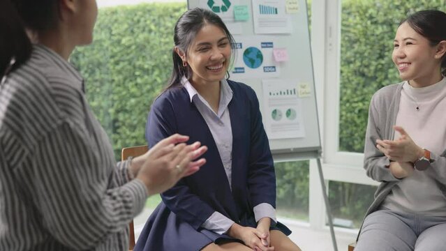 Circle diverse group asia people workshop eco go green seminar meeting class protect Future growth Net zero waste ESG unity office. Young adult asian man woman smile clap hand applaud happy team ideas
