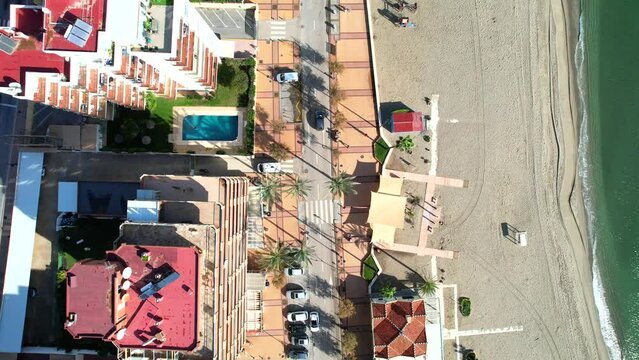Luxury buildings by the beach and sea, Spain. Top view of the popular beach and hotels.