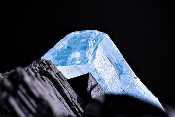 Aquamarine (blue beryl) on schorl (black tourmaline) macro photography detail texture background....