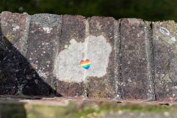 lgbt rainbow heart on the wall stone