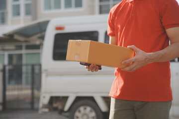 Asian delivery express courier young man use giving boxes to woman customer he wearing protective...