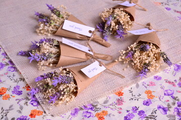 Wedding favors mini bouquet lavender purple flowers with craft paper wrapping, jute ribbon and...