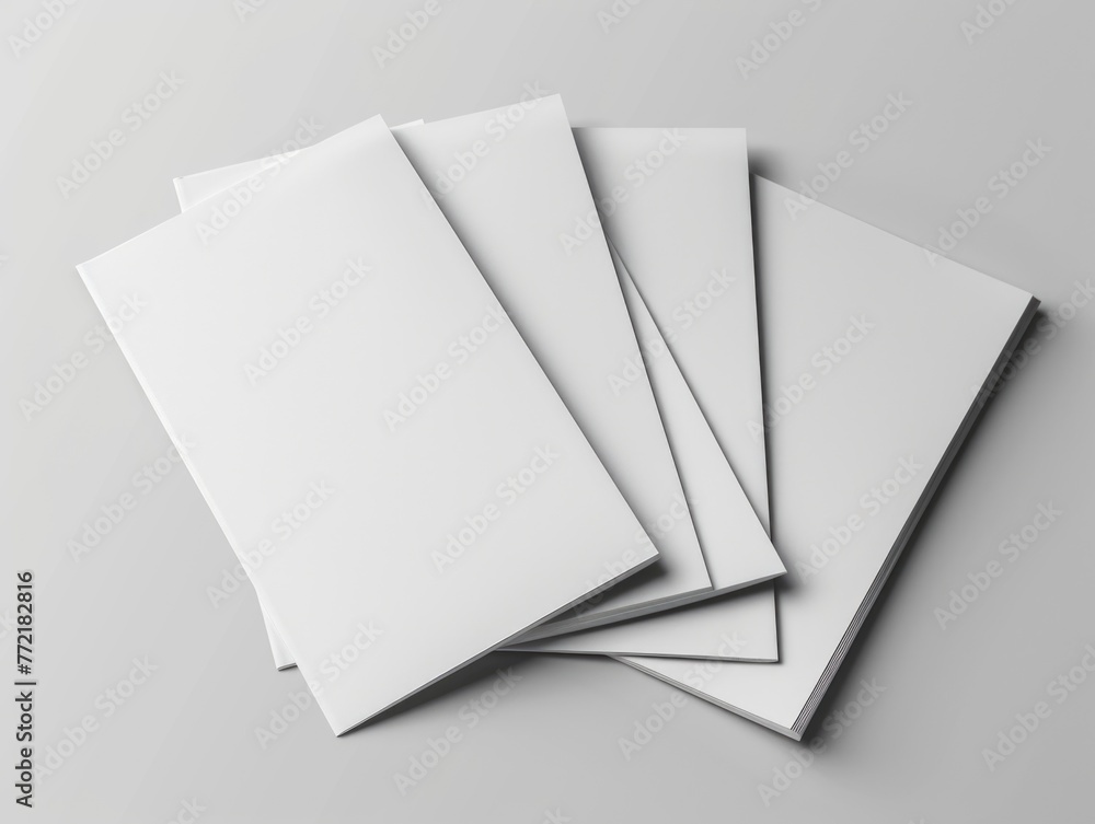 Poster a stack of white paper with no writing on it. the paper is square and is placed on a white surface