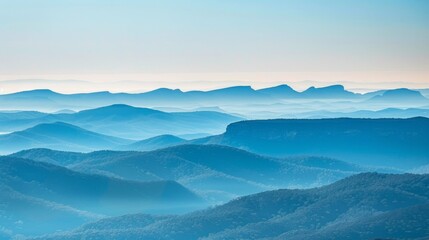 Layers of mountain ridges fade into the distance, their contours highlighted by a gentle haze, evoking a sense of serene vastness.