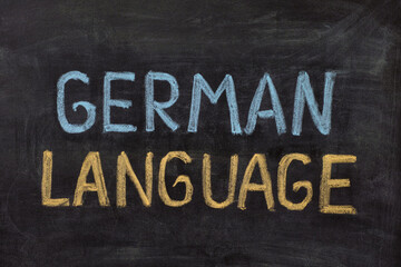 The words German Language handwritten with chalk on a blackboard.