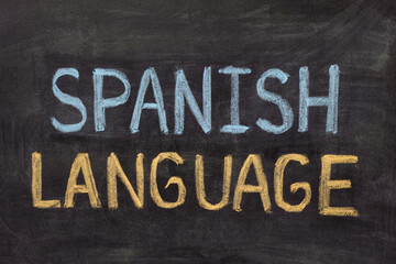 The words Spanish Language written in chalk on a blackboard.