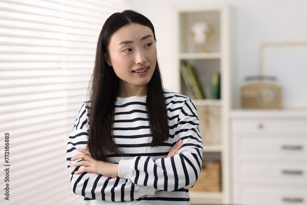 Sticker Portrait of smiling businesswoman with crossed arms in office