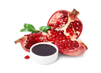 Tasty pomegranate sauce in bowl, leaves and fruits isolated on white