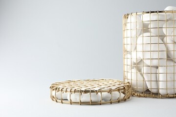Presentation for product. Podiums made of pebbles and wire basket on light grey background. Space...