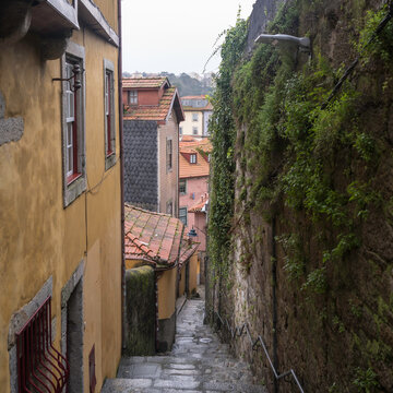 A narrow, rustic allyway, winding it way down the steep hills of Porto, the Portugese city