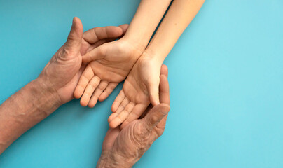 Generations Holding Hands Showcasing Family Unity Against a Blue Background