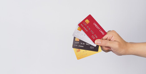 Hand is hold four credit cards on white background. - obrazy, fototapety, plakaty