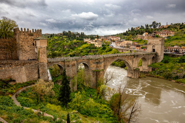 View of the medieval San Martin bridge in Toledo, Castila la Mancha, Spain, over the Tagus river