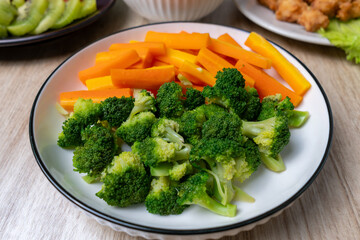Boiled Broccoli and Carrot server as a side with Chicken Pop Corn and Kiwi as a Dessert