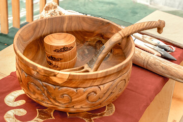 Traditional wooden utensils are sold at a street stall. Handmade