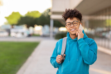 Young student talking on phone outdoors