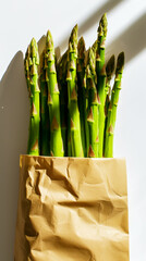 Fresh green asparagus in a paper bag on a white background. Healthy organic food concept. Generative AI