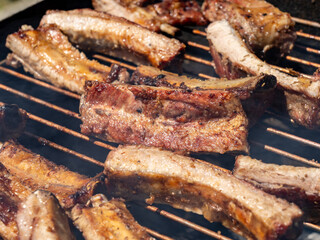 Roasted Juicy spare ribs cooked over the coals on a barbecue. Summer and holiday time. Delicious food